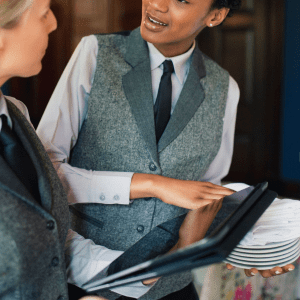 Receptionists Holding Plates and an Tablet